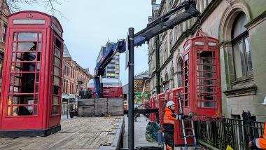 Telephone box being lifted by a crane on a truck